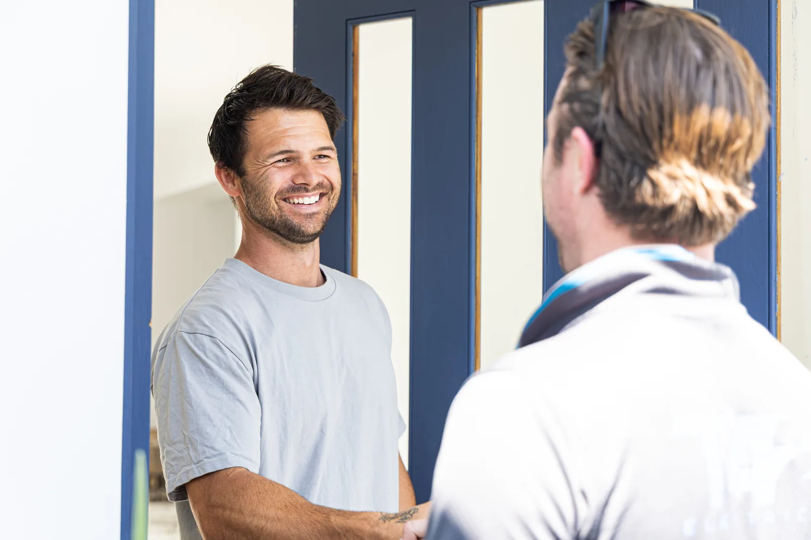 Happy customer shaking hands with their technician